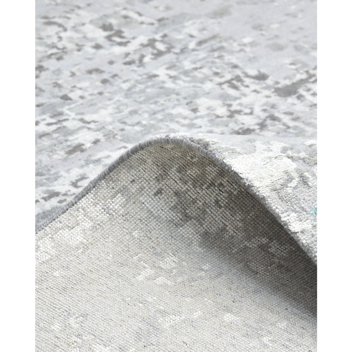 Close-up of a luxurious textured rug with a gray pattern.