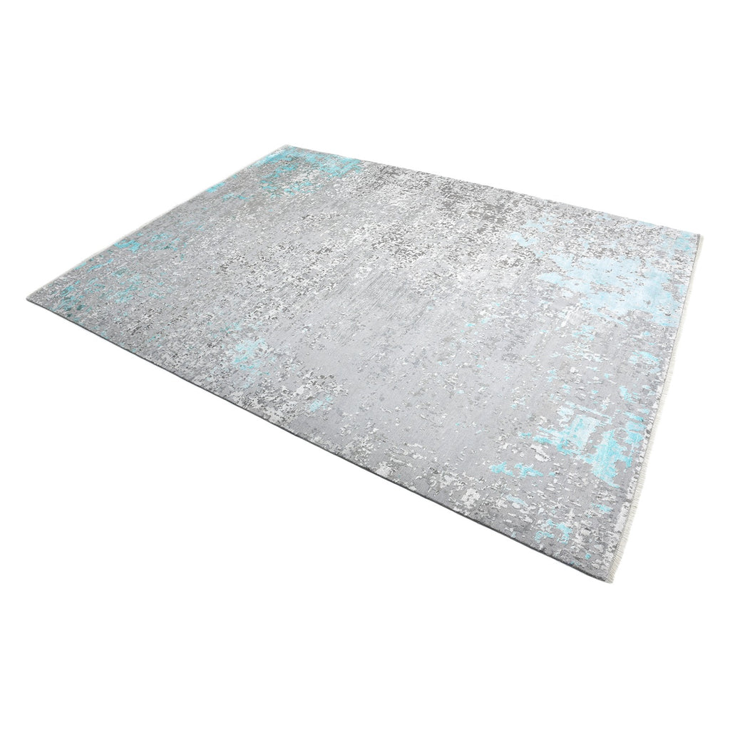 Vintage-inspired rectangular rug with distressed teal patterns for rustic charm.