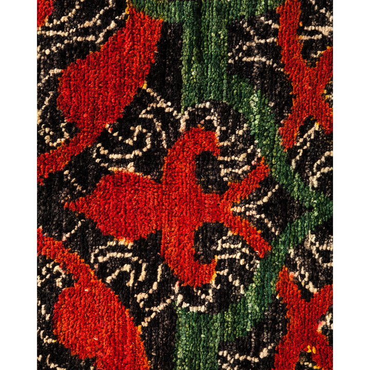 Close-up of a textured, handcrafted floral textile with bold colors.