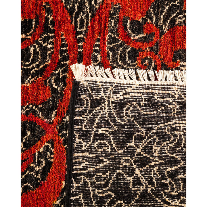 Intricate Persian-style rug with bold red and black design.