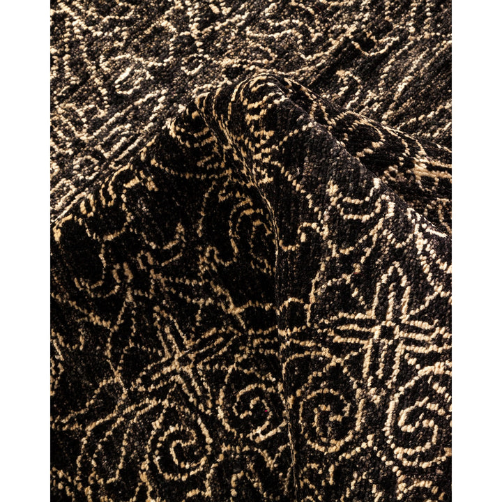 Close-up of textured fabric with intricate swirl and loop pattern.