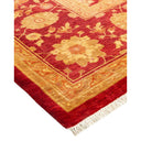 Traditional ornamental rug with rich red background and gold motifs.