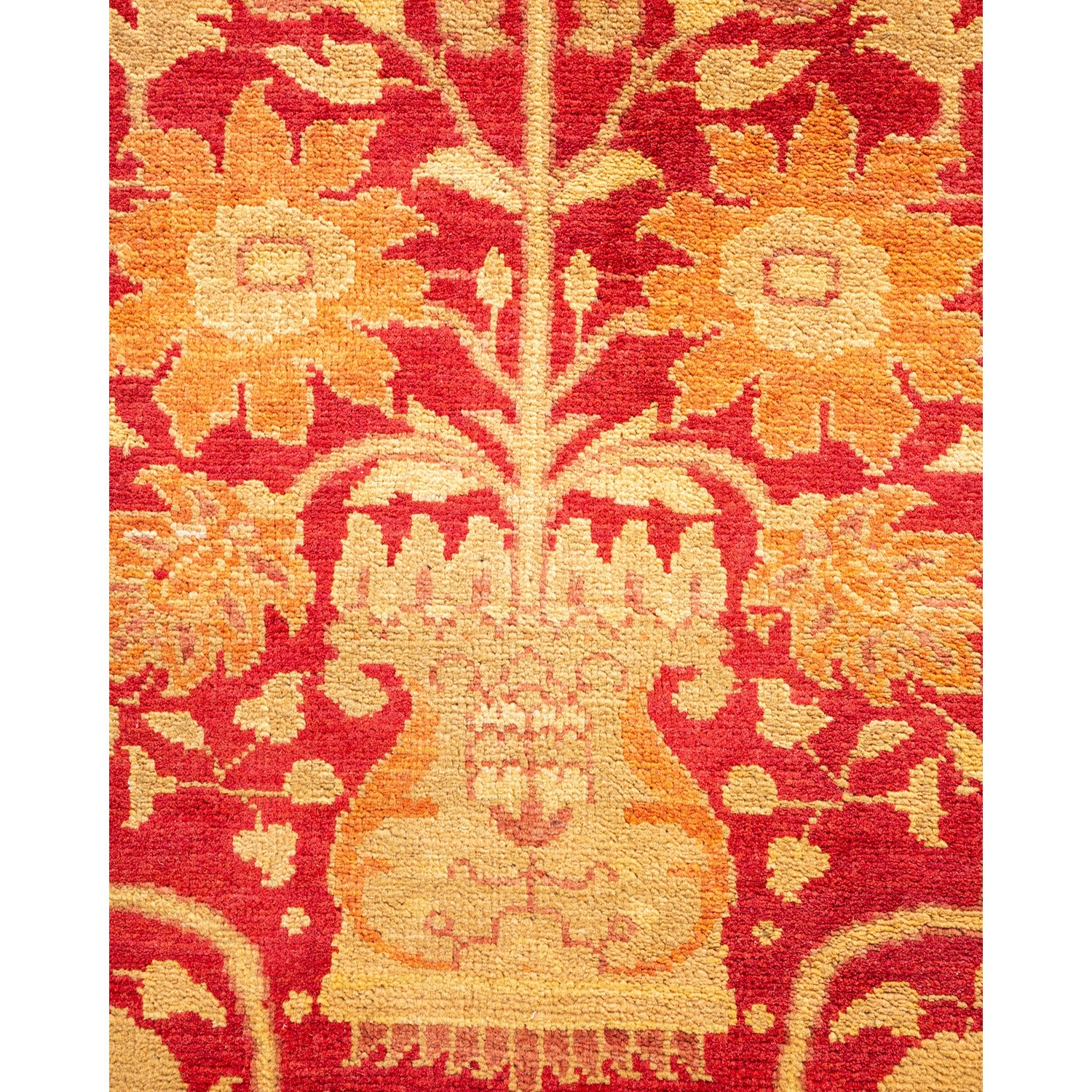 Intricate handcrafted rug with warm floral motifs in red and cream.