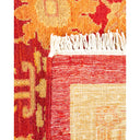 Detailed close-up of a vibrant, handcrafted woven rug with tassels.