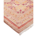Vintage-style area rug with ornate floral motif and fringed edges