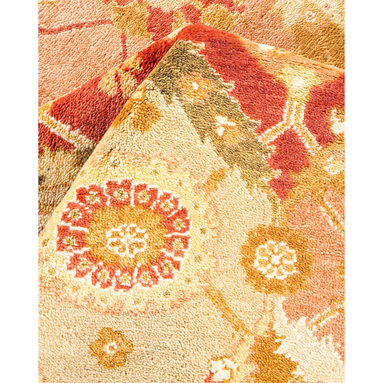 Close-up of a warm, textured rug with intricate floral pattern
