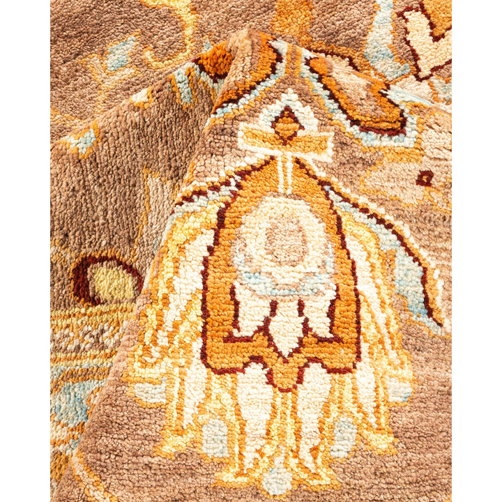 Close-up of a handwoven, intricate rug displaying warm colors and cultural influences.