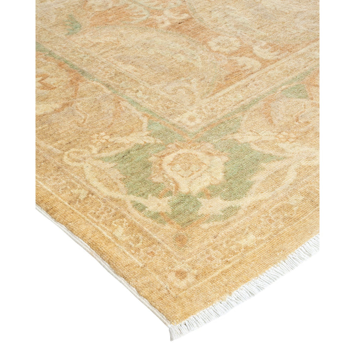 Vintage rug with faded floral pattern in beige and green.