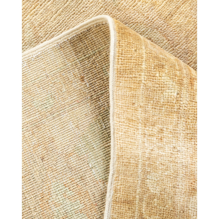 Close-up of a textured beige rug with folded corner.