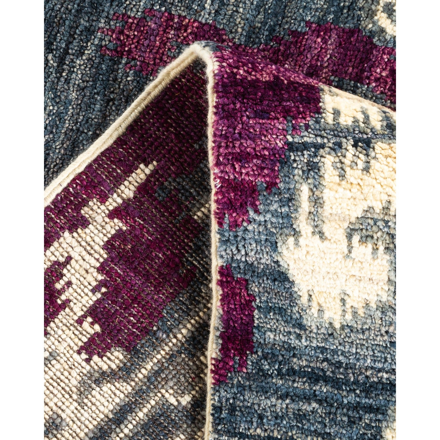 Intricate handcrafted rug showcases detailed texture and rich color palette.