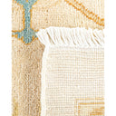 Close-up of a handcrafted textile rug with fringed edges.