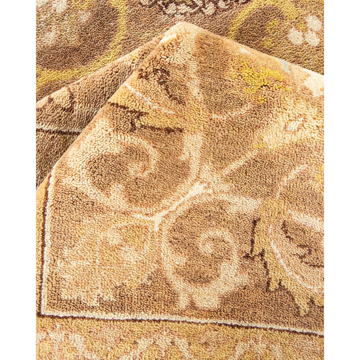 Close-up of a plush, patterned carpet with beige and brown tones.