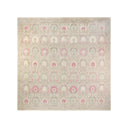 Intricate pastel rug with medallion pattern and floral motifs.