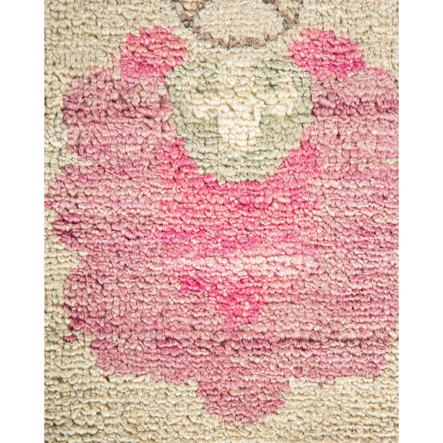 Close-up of a tufted fabric with a floral-like pink pattern.