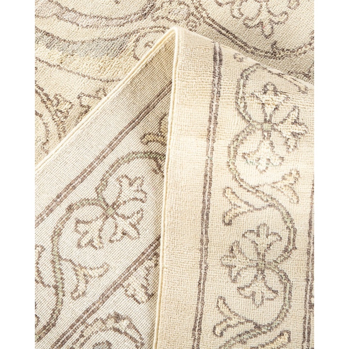 Side view of a rolled-up, traditional-style carpet with floral motifs.