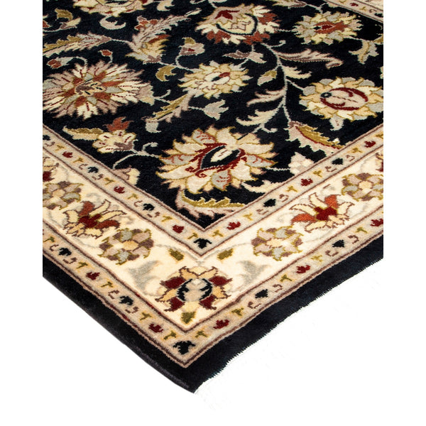 Intricately designed navy rug with floral motifs and plush appearance.