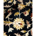 Close-up of a deep navy fabric with intricate floral pattern.