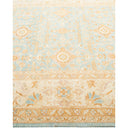 Oriental-style rug with floral and geometric motifs in pastel hues.