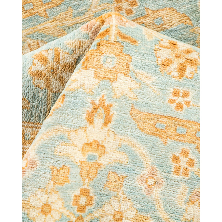 Close-up of a woven textile with floral motifs in soft colors.