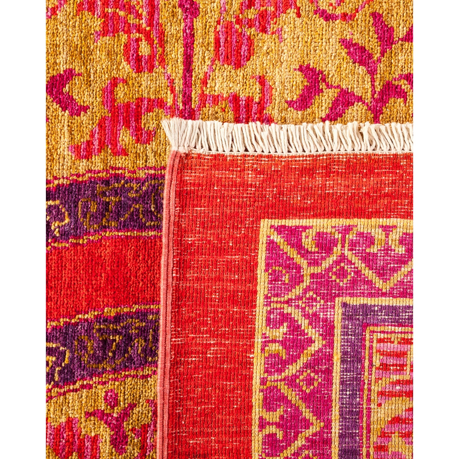 Close-up of colorful textile with intricate patterns and vibrant hues.