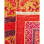 Close-up of colorful textile with intricate patterns and vibrant hues.