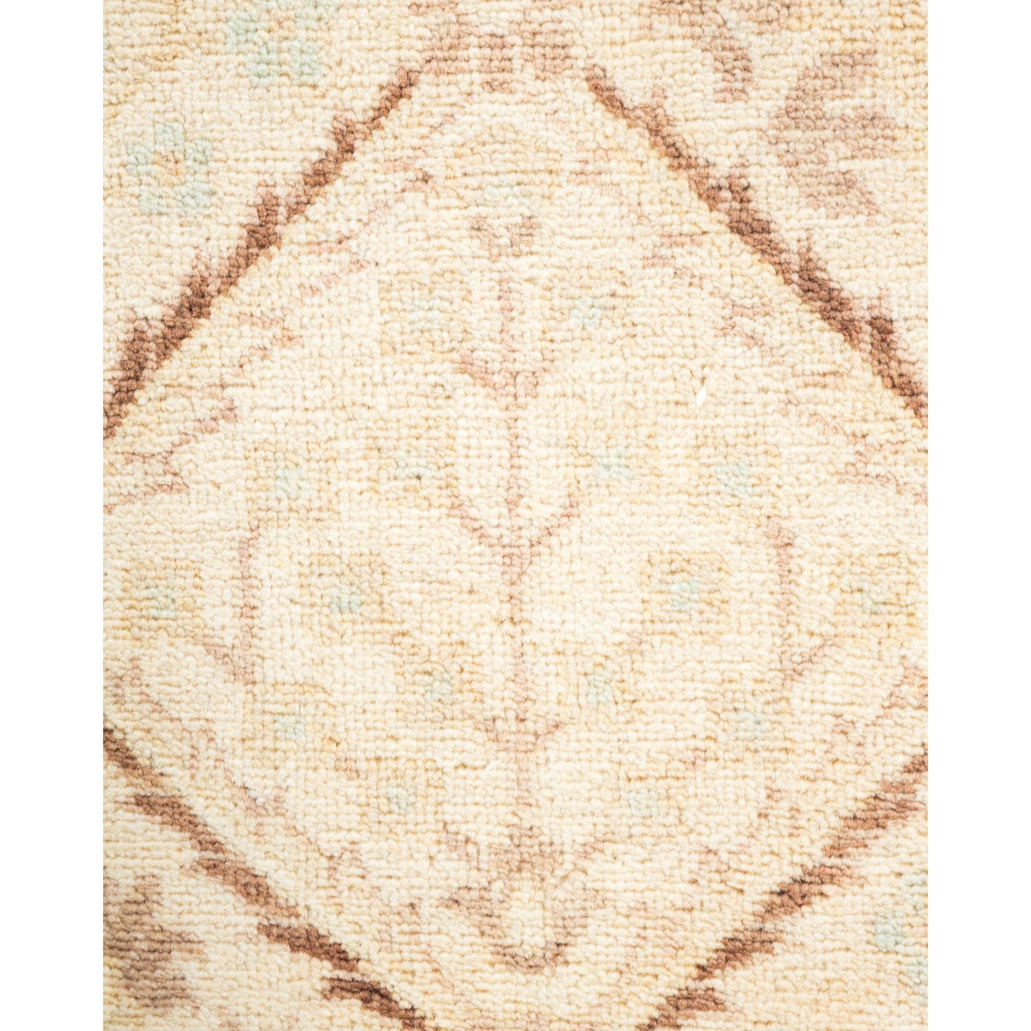Close-up of a soft and ornate rug with neutral tones.