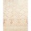 Decorative rug with diamond and floral motifs in neutral tones.