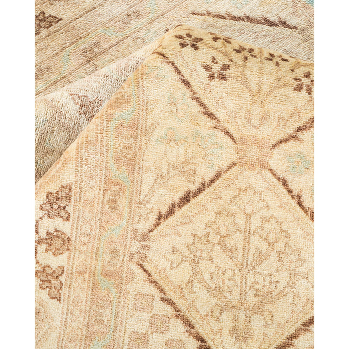 Intricate handwoven rug with symmetrical floral motifs in neutral hues.