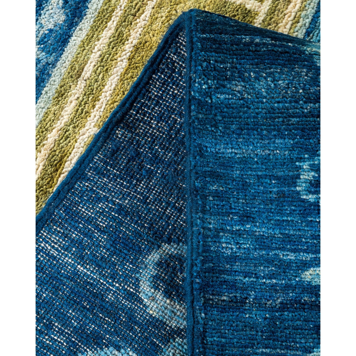 Close-up of a textured blue fabric with folded edge and striped background.