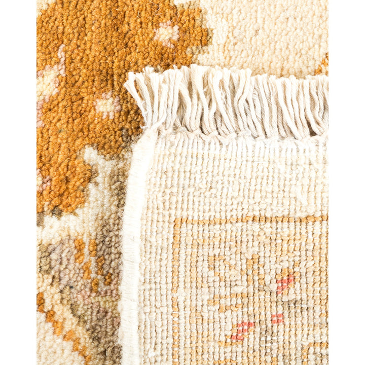 Close-up of a floral patterned rug with fringed edges