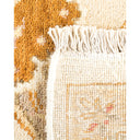 Close-up of a floral patterned rug with fringed edges