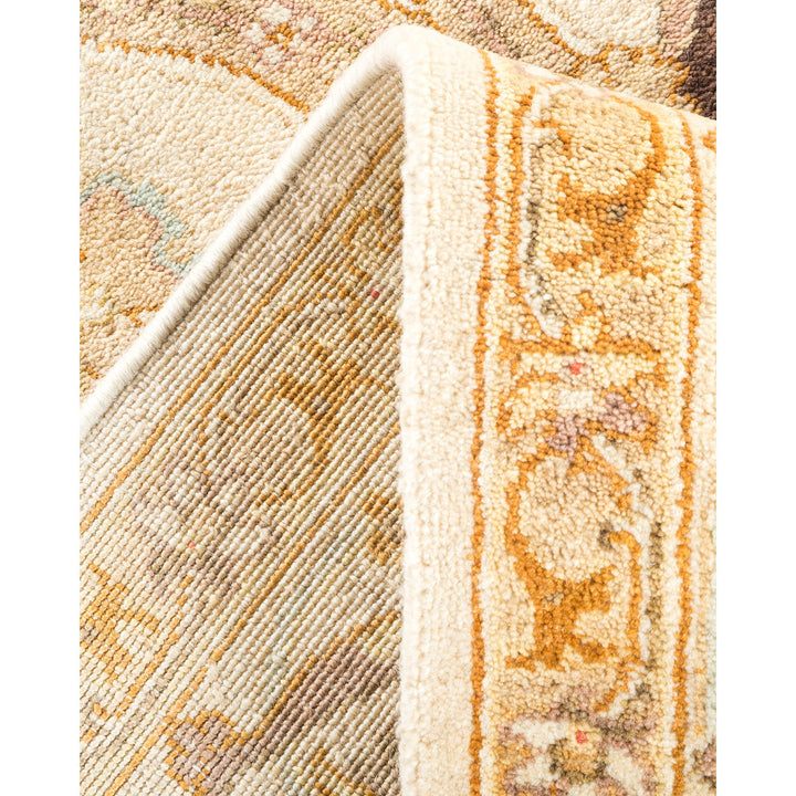 Close-up of intricate, textured carpet with floral design and rich colors.
