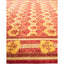 Exquisite, symmetrical design carpet with intricate patterns in red and gold.