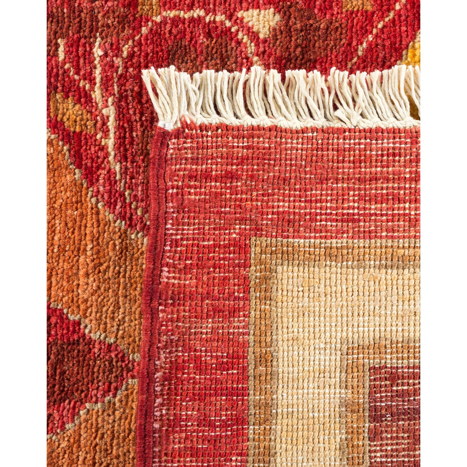Intricately woven rug with neat fringe and vibrant geometric pattern.