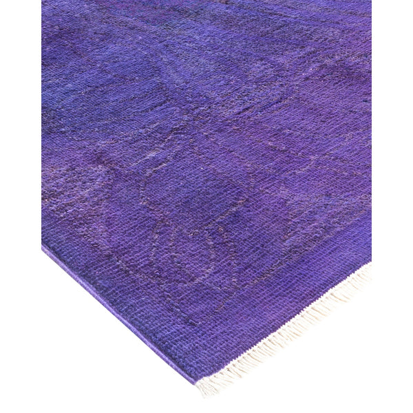 Close-up of a plush purple rug with intricate woven pattern