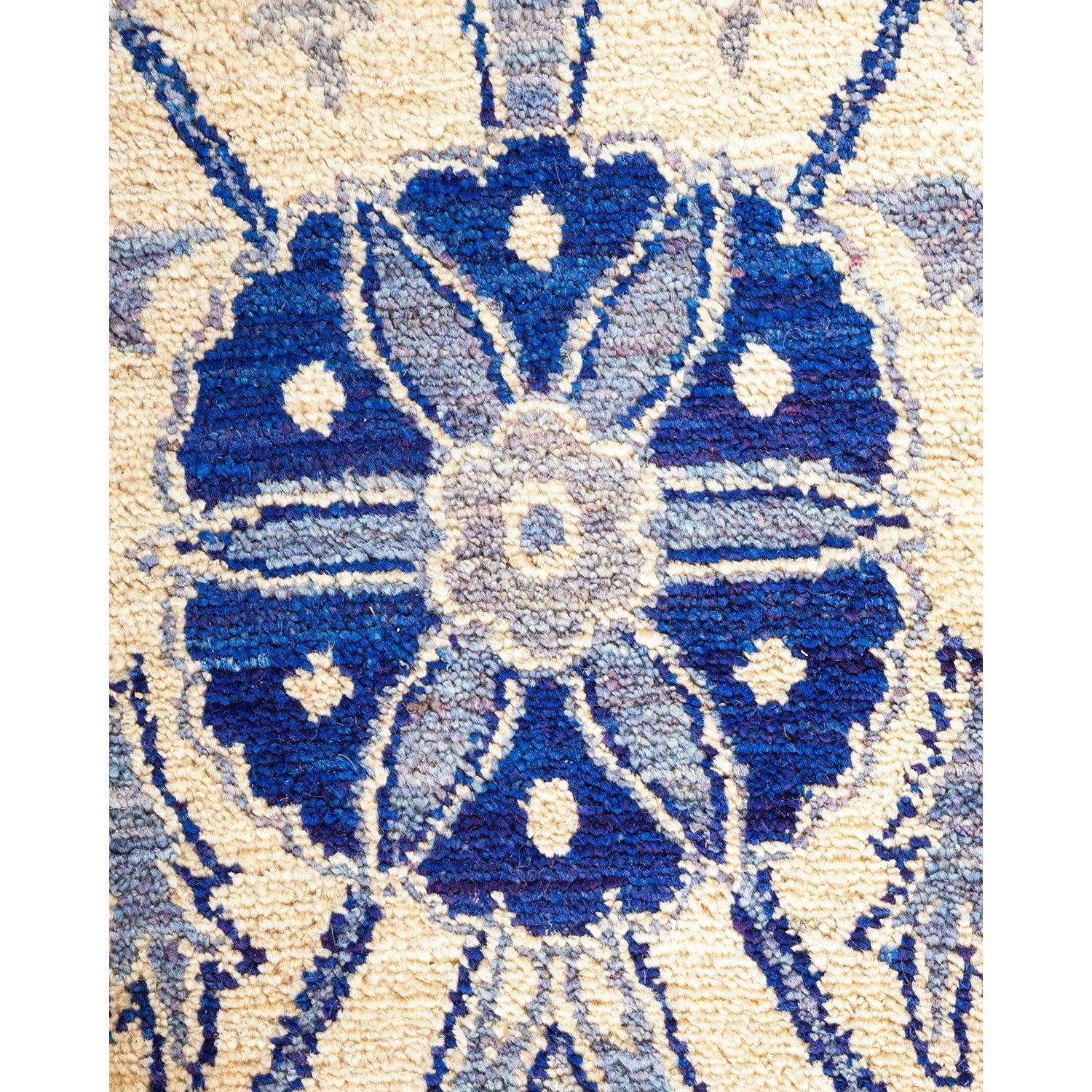 Intricate symmetrical design of a plush blue textile with beige.