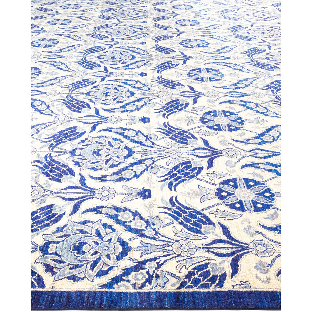 Intricately designed blue and cream area rug with floral motifs.