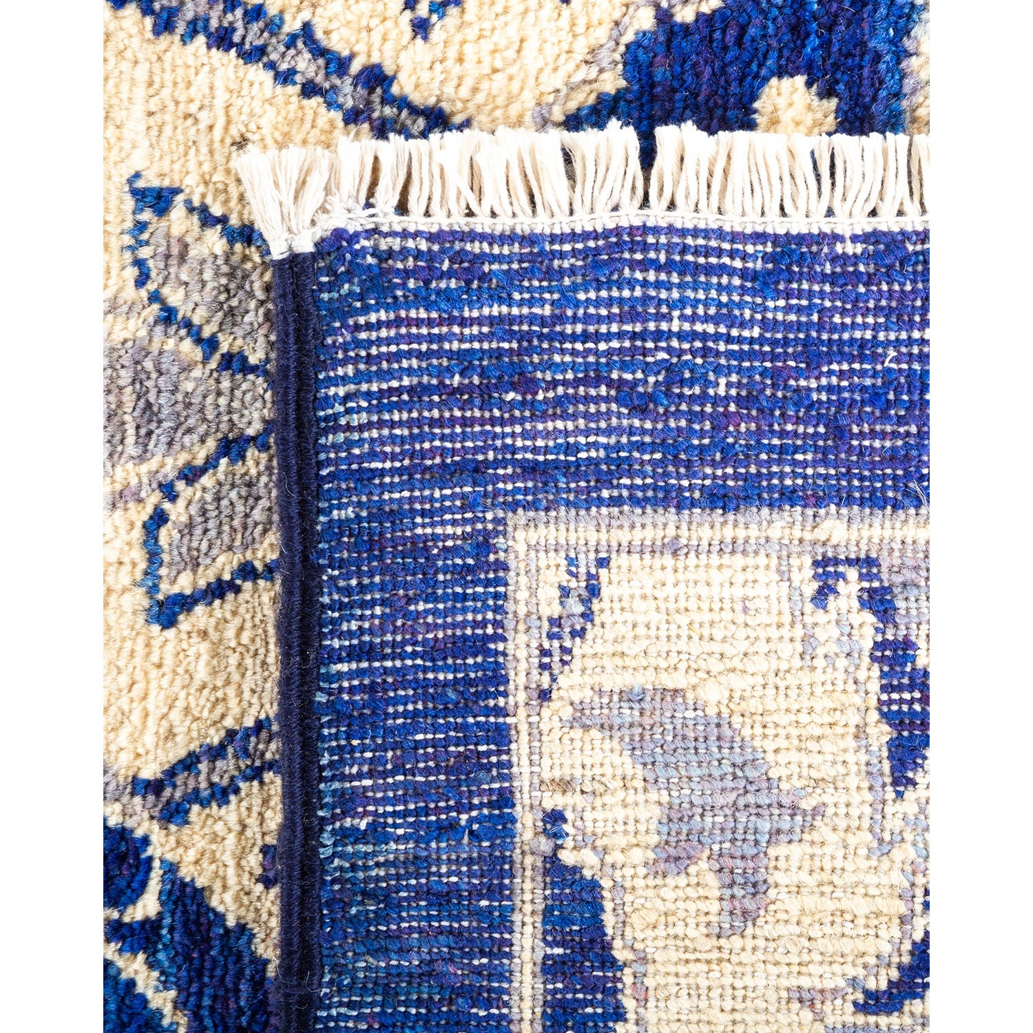 Intricate handwoven rug with geometric patterns in blue and cream.