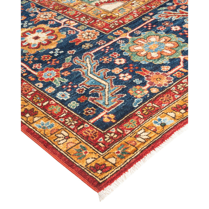An intricately designed handcrafted rug showcases vibrant colors and patterns.