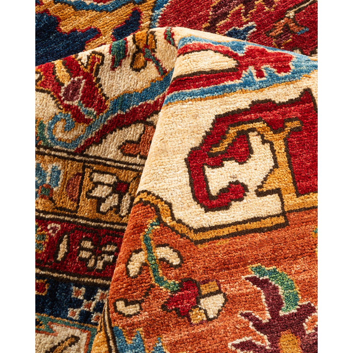 Vibrant, intricate hand-knotted rug showcases rich geometric and floral motifs.