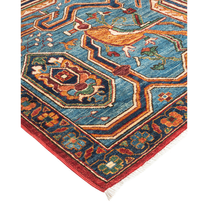 Intricately designed rug with vibrant colors and detailed geometric motifs.