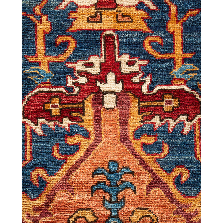 Intricately patterned handmade rug featuring vibrant colors and symmetrical design.