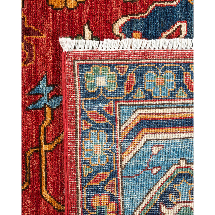 Close-up of a handcrafted rug with intricate geometric and floral motifs.