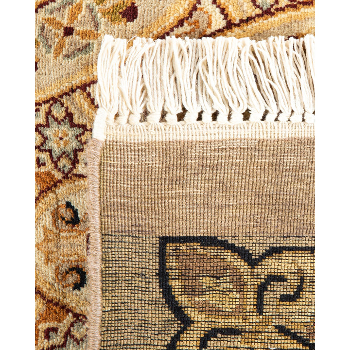 Close-up of handcrafted woven rug with intricate traditional floral pattern.