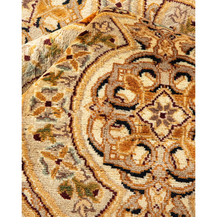 Close-up of an ornate, plush, patterned carpet in earthy colors.