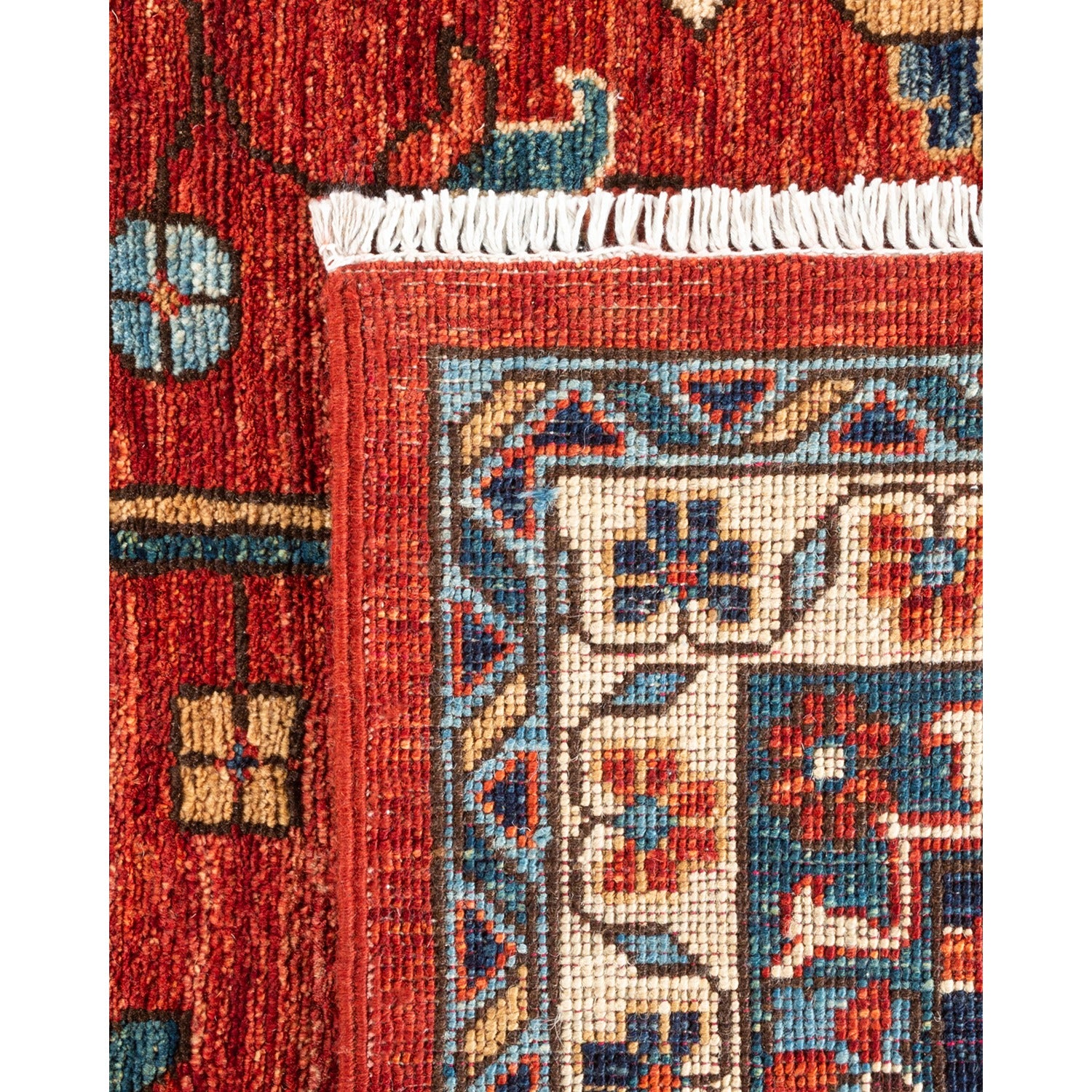 Close-up view of a handwoven rug showcasing intricate geometric and floral patterns in a rich color palette.