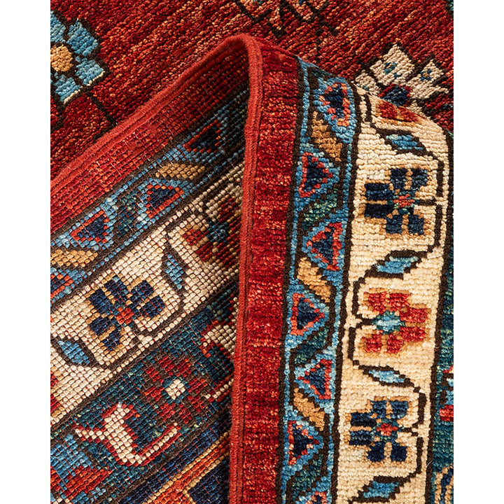 Close-up of richly textured, colorful woven carpet with intricate patterns.