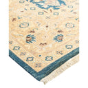 Intricately designed rug with botanical motifs in shades of blue