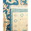 Intricately designed rug with floral and curvilinear elements in blue.