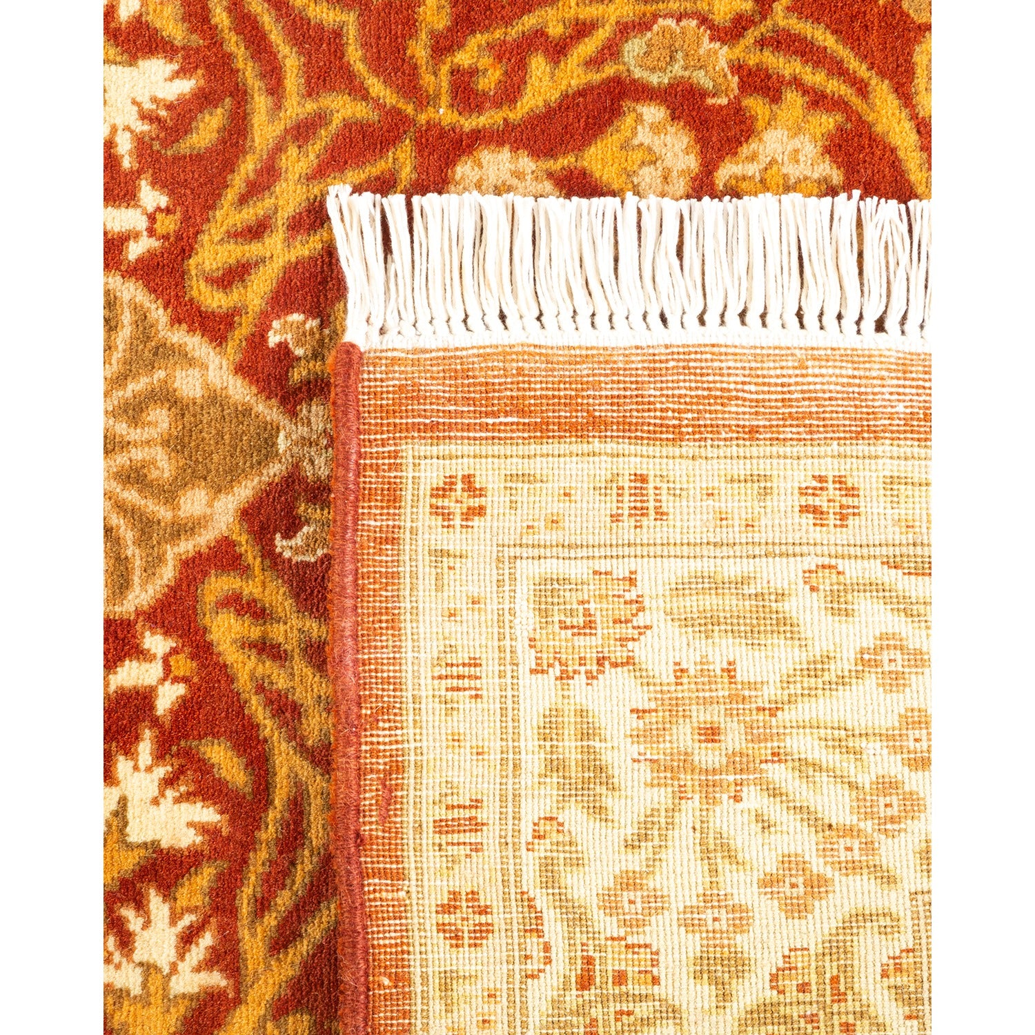 Close-up of hand-woven rug showcasing intricate patterns in warm tones.